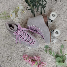 Load image into Gallery viewer, The Seed Project roller skates. colour is Alpines with pink leopard laces surrounded by flowers and leaves.