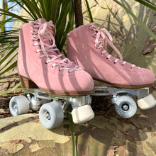 Load image into Gallery viewer, The Seed Project SeedPro* roller skates. colour is Galah with light pink laces sitting on a rock infront of a plant