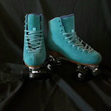 Load image into Gallery viewer, The Seed Project roller skates. Colour is Tui with turquoise laces on a black backdrop.

