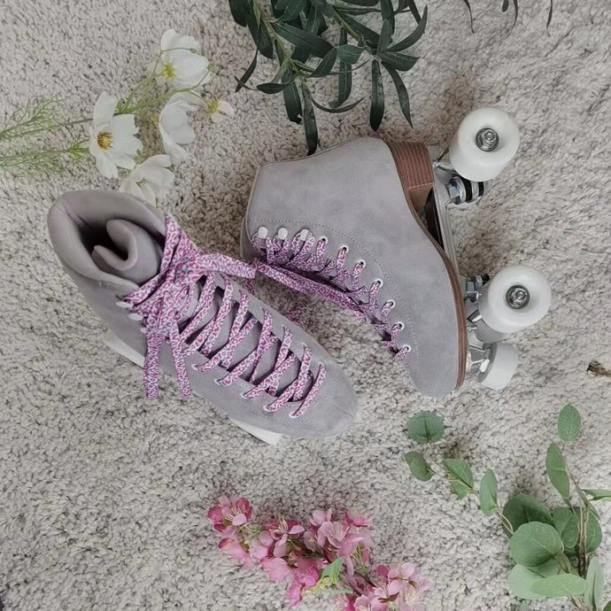 The Seed Project roller skates. colour is Alpines with pink leopard laces surrounded by flowers and leaves.