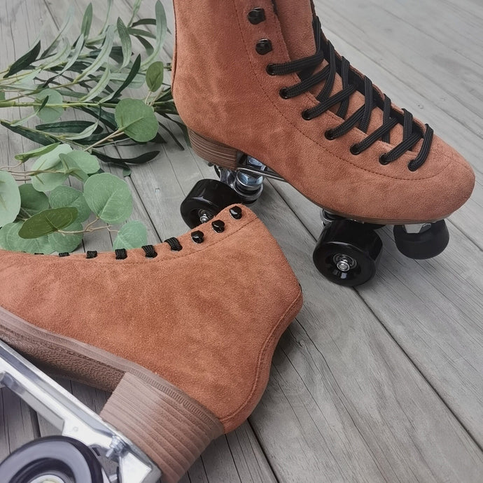 The Seed Project roller skates. Colour is Tieke with black laces on a wooden background surrounded by leaves.